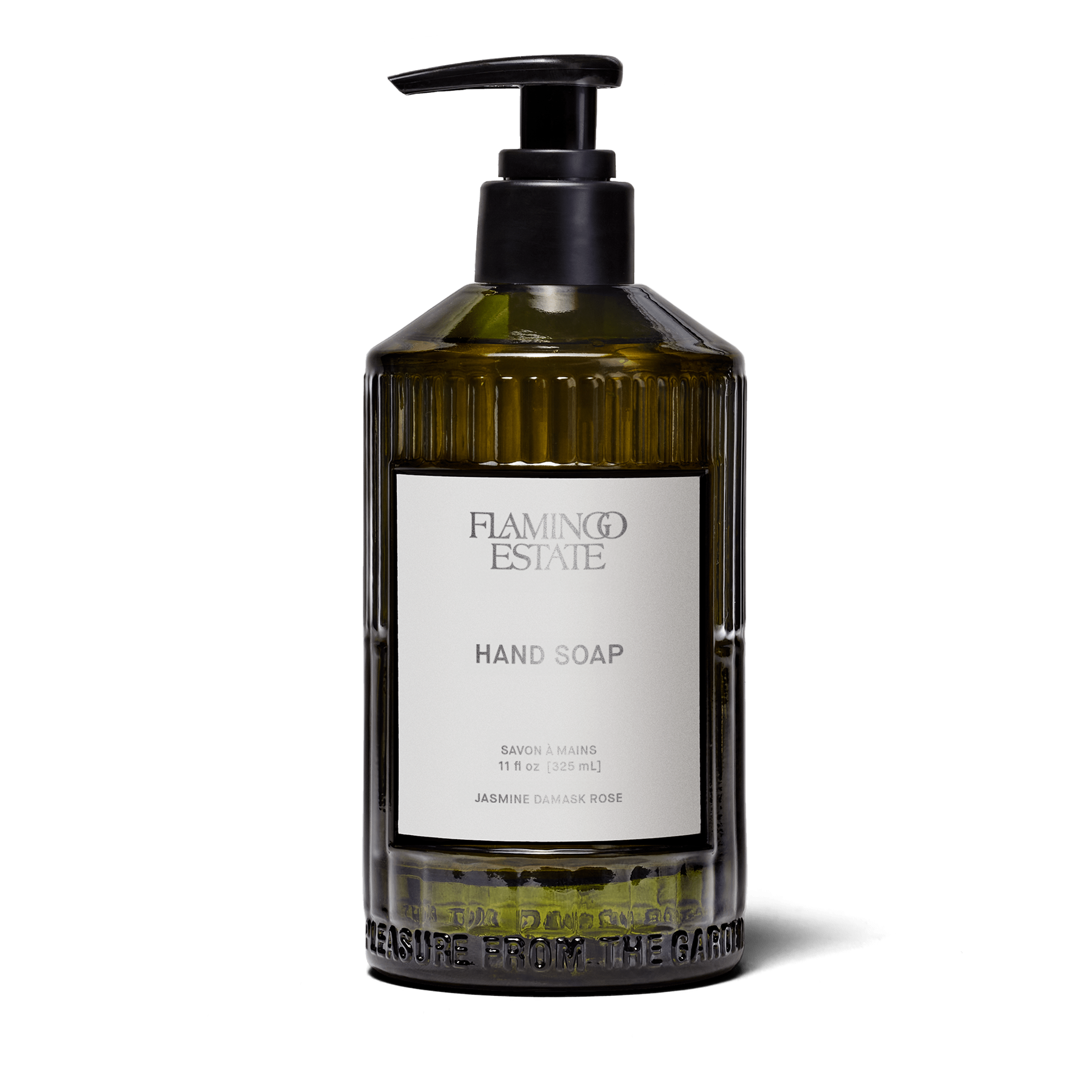 A fluted forest-green glass bottle of Flamingo Estate Jasmine Damask Rose Hand Soap with a brushed-metal pump dispenser, photographed centered on a clean white background.