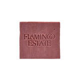 The dusty rose-pink Jasmine Damask Rose Soap Brick from Flamingo Estate, embossed with the brand wordmark, sits centered on a clean white background.