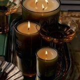 Flamingo Estate Jasmine Damask Rose three-wick soy wax candle in a dark glass vessel on a decorative tray.