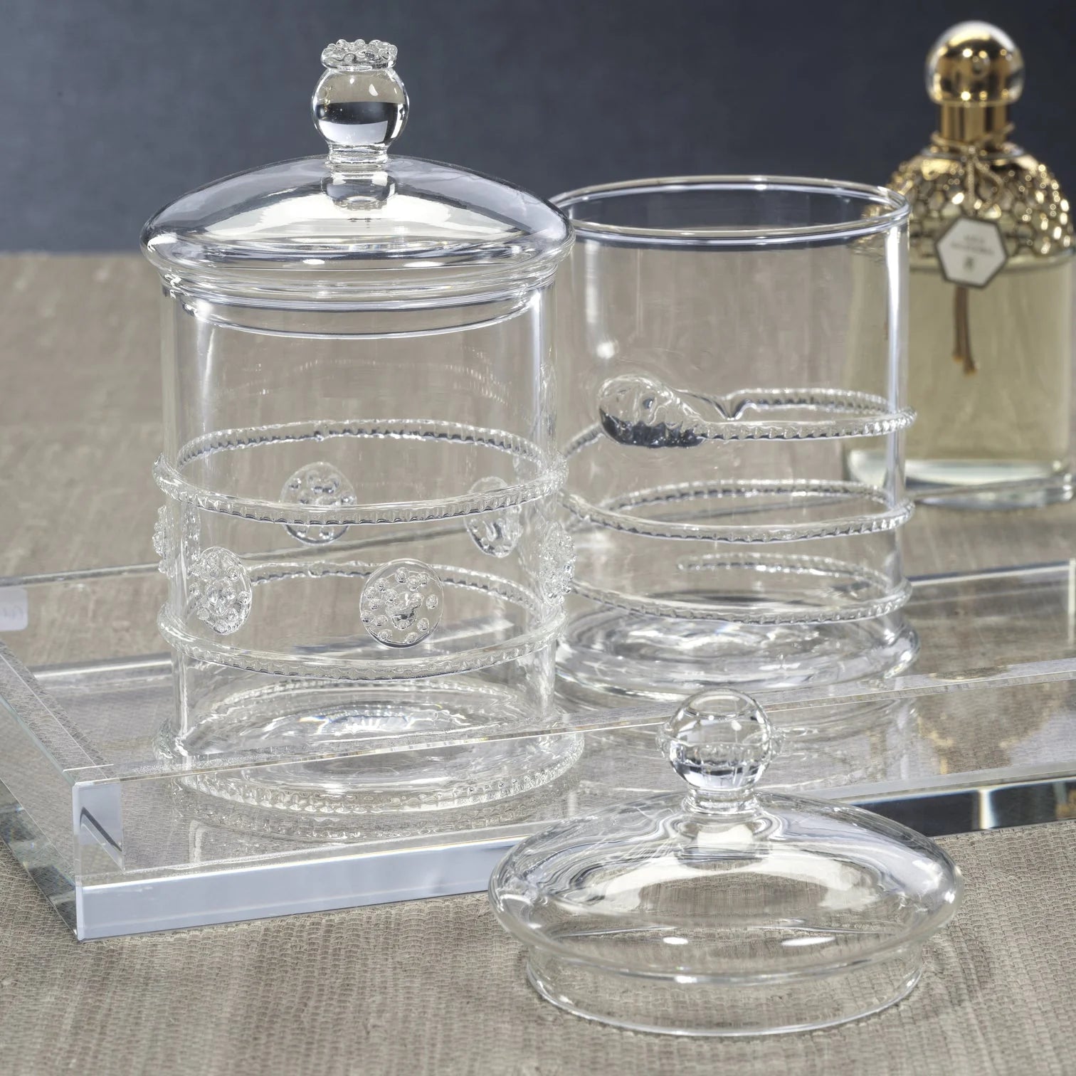 Juliet Lidded Glass Jar styled on a surface showing hand-detailed glass construction