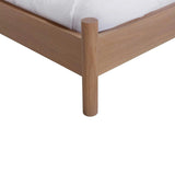 Calimia Home Kelma Bed corner detail featuring natural white oak frame and cylindrical leg