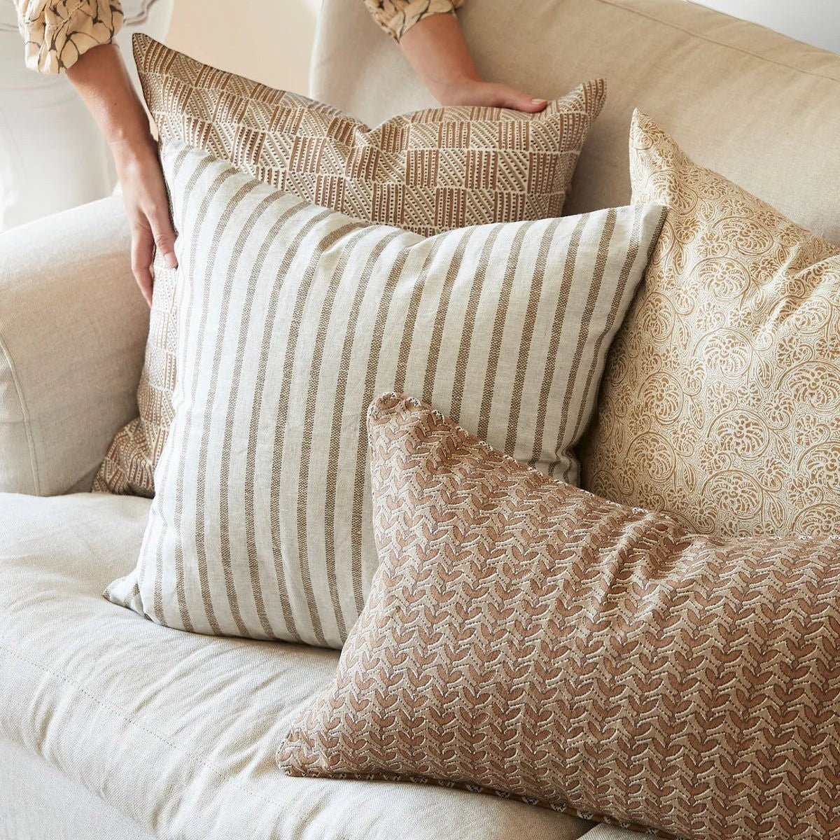 Walter G Kythira Washed Pista decorative throw pillows with textured patterns and stripes on a beige sofa
