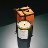 Flamingo Estate Leather Appointment candle in a forest-green fluted glass vessel with orange gift box