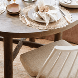 Valencia X round oak dining table set for dinner with Lewis Windsor chairs in the Calimia Home showroom