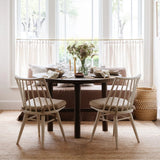 Valencia X Dining Table with Lewis Windsor chairs and a linen banquette under tall windows at Calimia Home