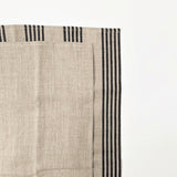 Be Home set of two Belgian linen dish towels in natural beige with black woven stripes on a white background