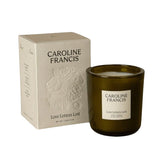 Caroline Francis Love Letters Lost scented candle in a dark glass jar with a cream embossed box featuring floral details.