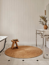Armadillo Lucine Nook Rug in Natural, a second view of the hand-braided jute rug in a styled interior