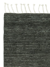 Armadillo Malawi Rug in Kelp, corner close-up of the wool pile and edge