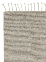 Armadillo Malawi Rug in Feather, corner close-up of the wool pile and edge