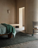 Armadillo Malawi Rug in Kelp, hand-knotted wool rug shown in a room setting