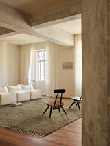 Armadillo Malawi Rug in Olive, hand-knotted wool rug shown in a room setting