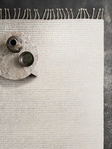 Armadillo Malawi Rug in Tapioca, overhead view of the hand-knotted wool weave and edge finish