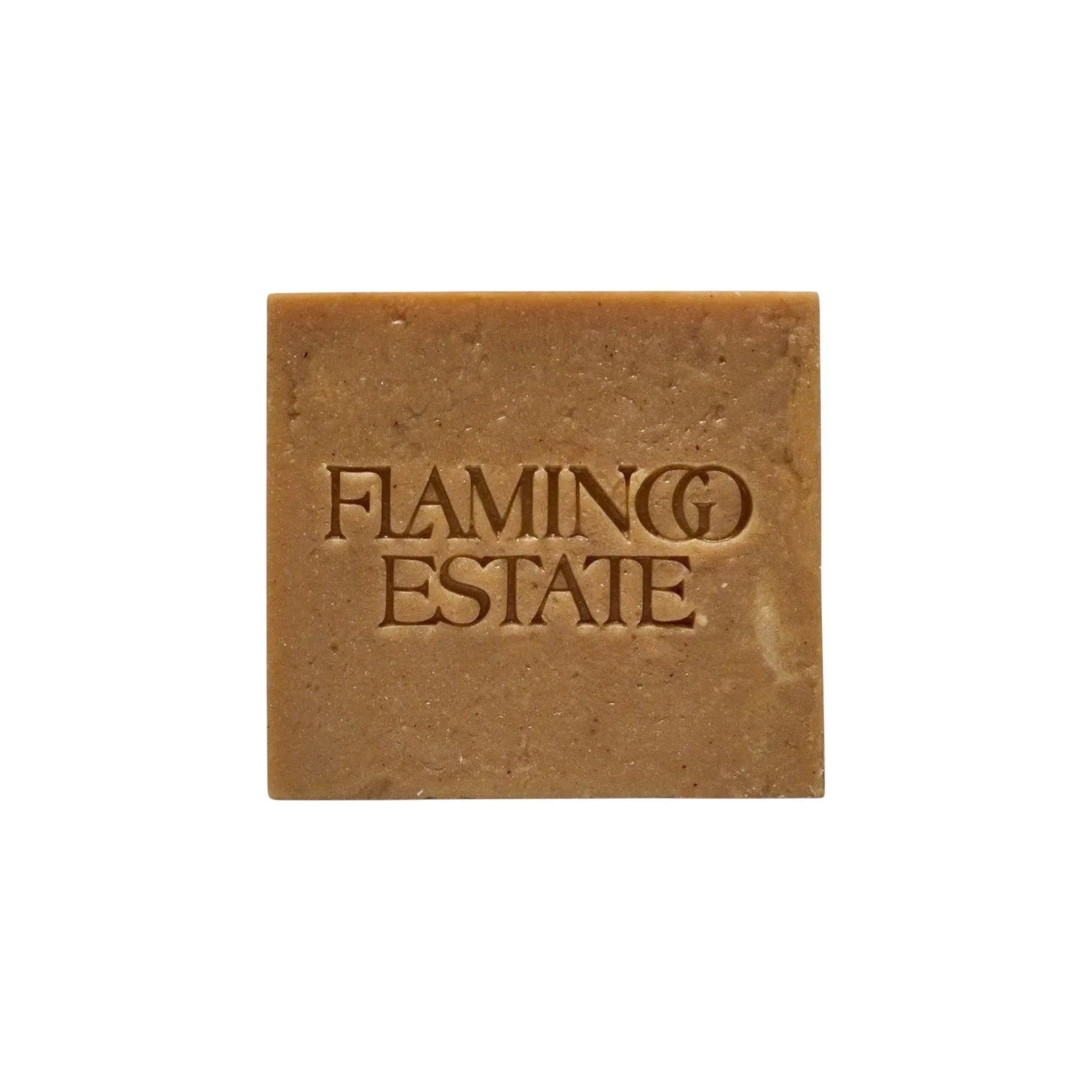 Flamingo Estate Manuka honey soap brick with shea butter and hemp oil, featuring a square shape and embossed logo.