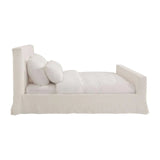 Calimia Home Mara Bed in white with a fully slipcovered frame and soft tailored aesthetic, side view.