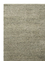 Armadillo Meadow Rug in Pistachio, corner close-up of the wool pile and edge