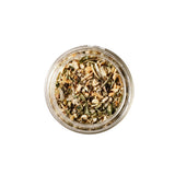Calicutts Mediterranean spice blend in a glass jar, featuring dried garlic, herbs, and sun-dried tomato pieces.