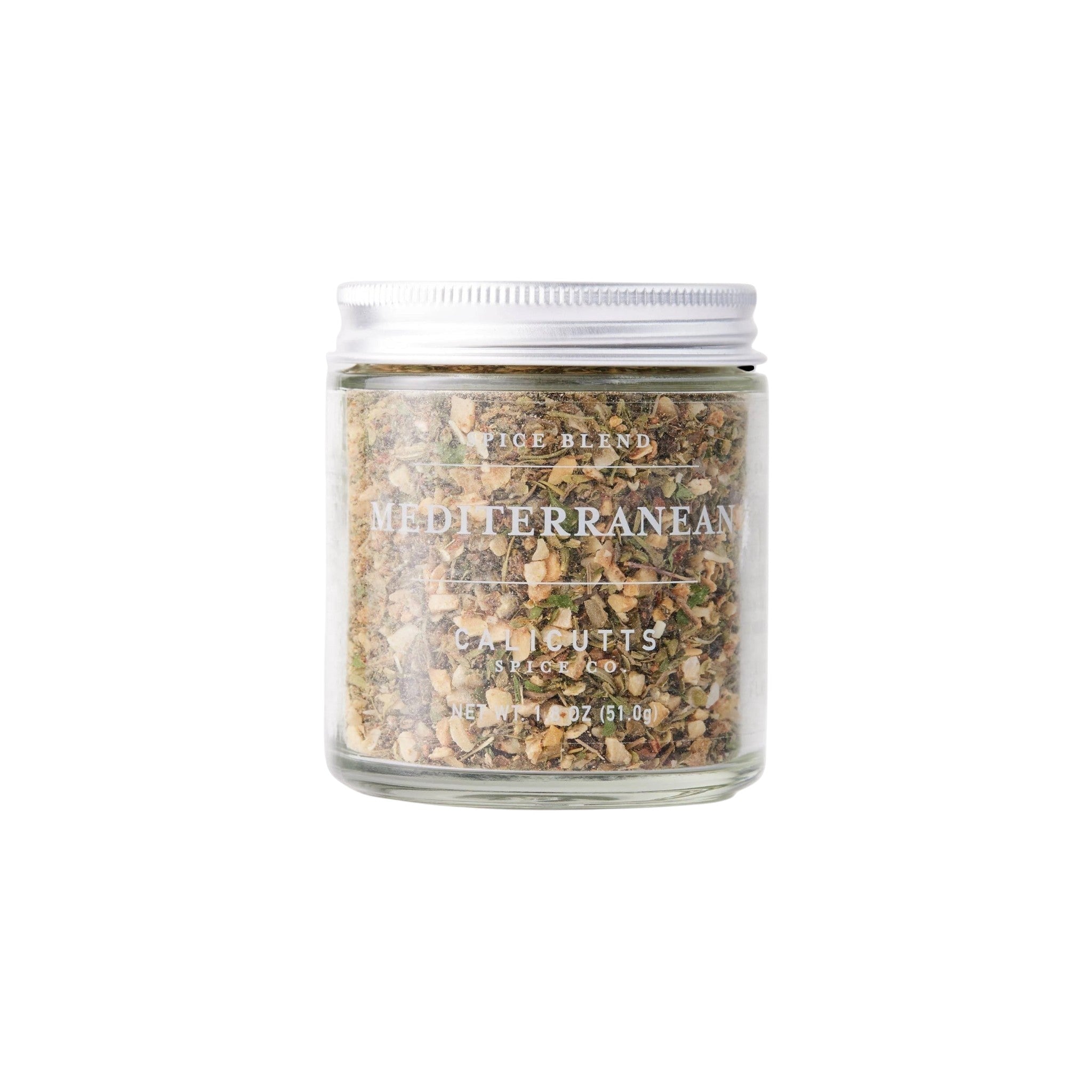 Calicutts Mediterranean spice blend in a clear glass jar with a silver lid, featuring dried herbs and garlic.
