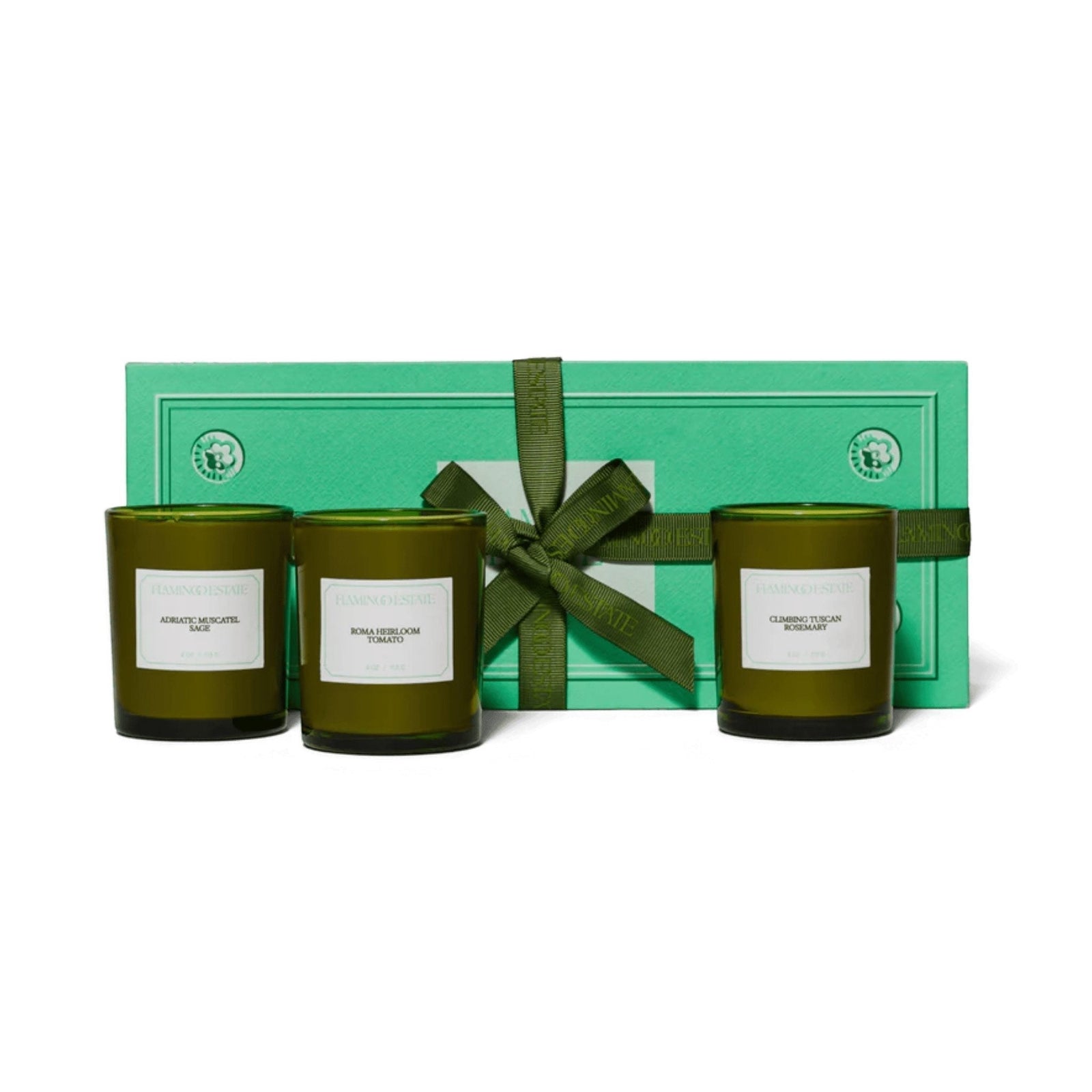 Flamingo Estate Mini Three Sisters Candle Gift Set: three small green glass candles in Sage, Tomato, and Rosemary in a branded green gift box.