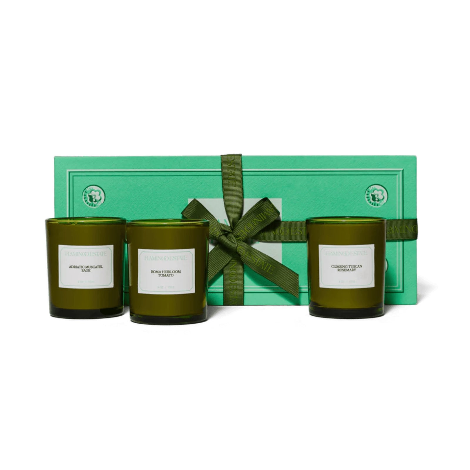 Flamingo Estate Mini Three Sisters Candle Gift Set: three small green glass candles in Sage, Tomato, and Rosemary in a branded green gift box.