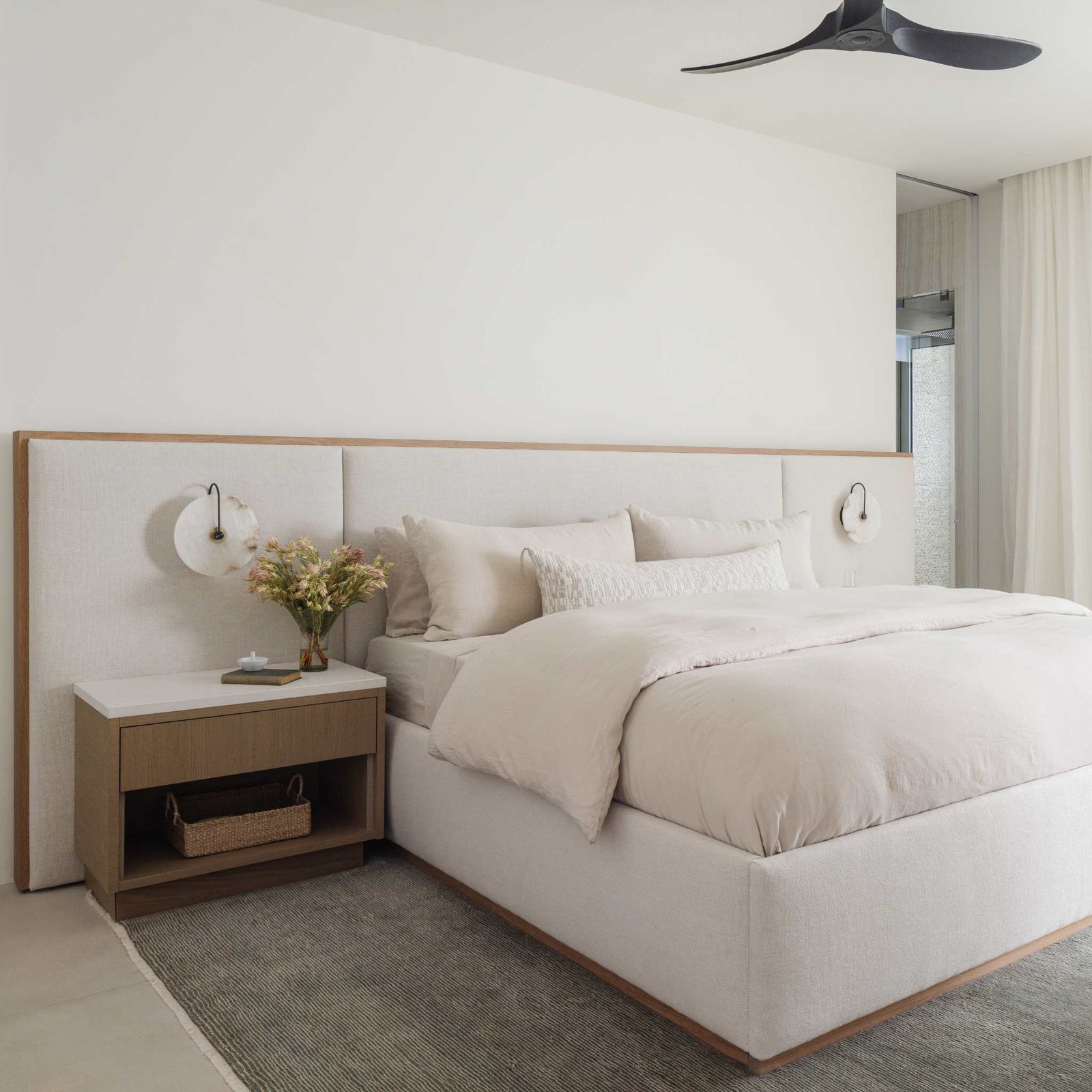 Mira Long Lumbar Pillow detail — elongated silhouette with corner tassels, styled on a bed or bench