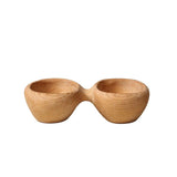 A small carved beechwood bowl on a plain background.