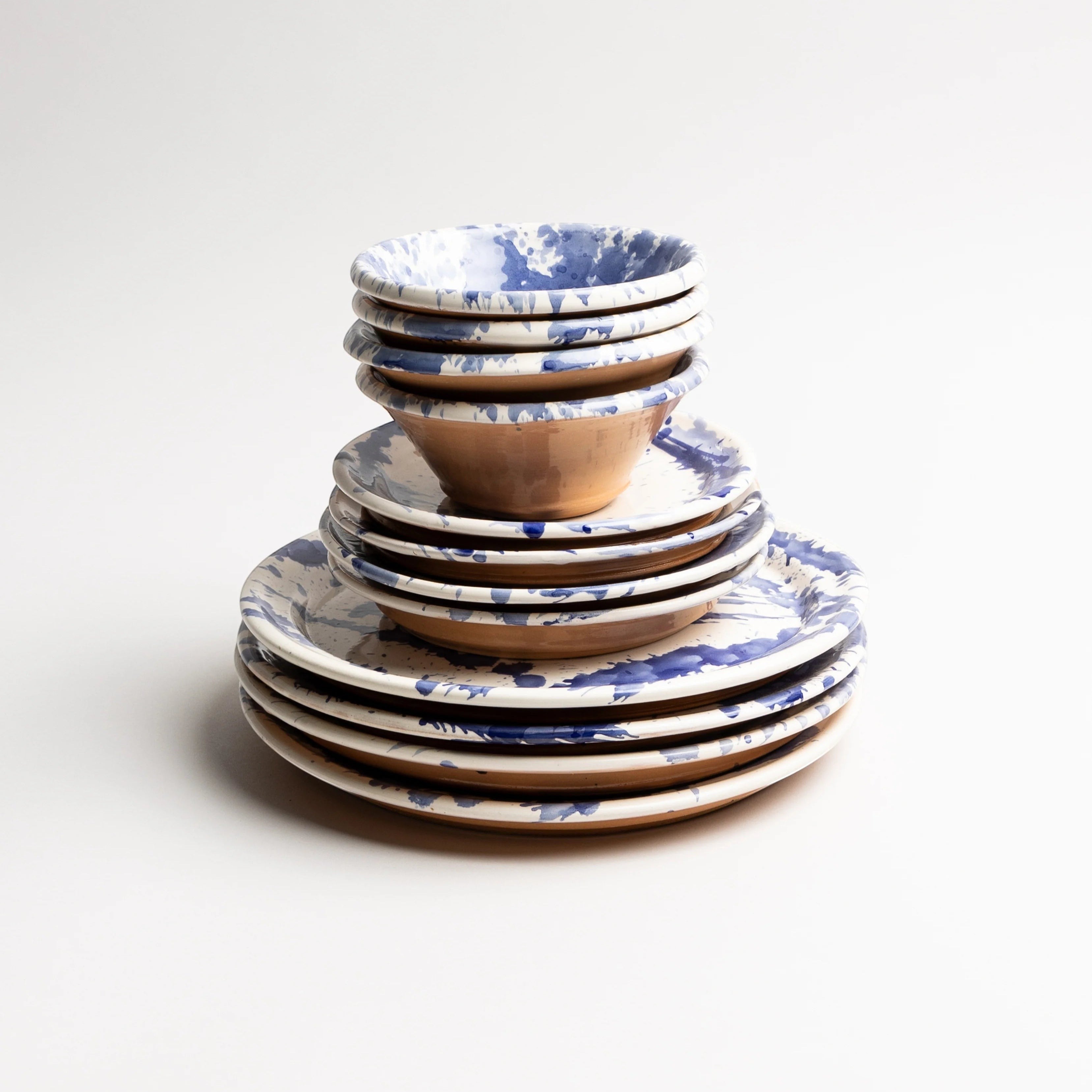 Hand-thrown Italian terra cotta mixing bowl in blue splatter glaze