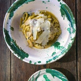 Hand-thrown Italian terra cotta mixing bowl in green splatter glaze