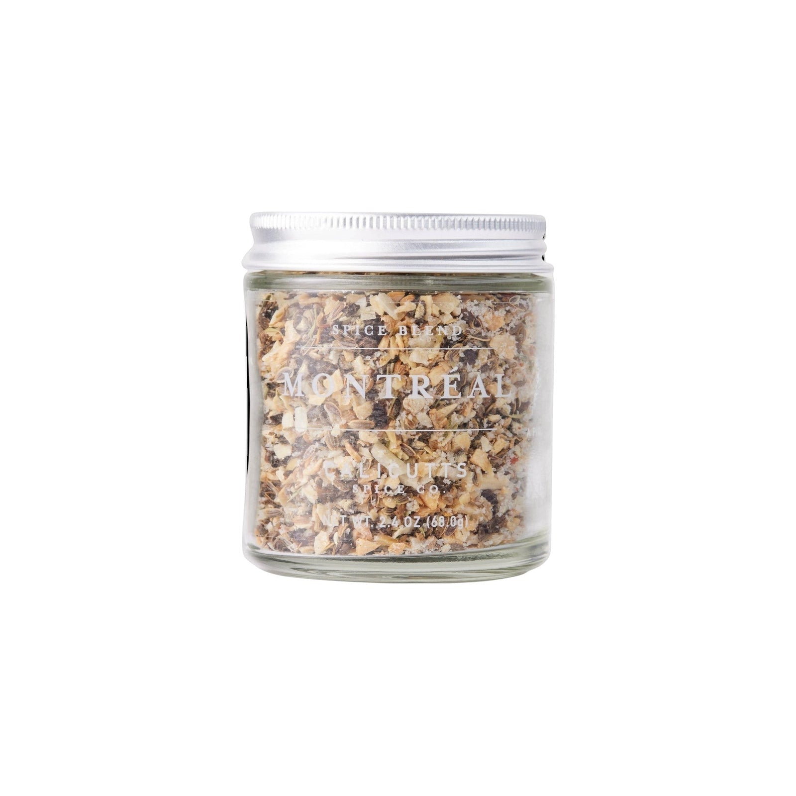 Calicutts Montreal spice blend in a clear glass jar with a silver lid, featuring coarse garlic, peppercorn, and dill.