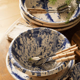 Sir Madam natural linen cocktail napkins with frayed edges stacked beside blue and white splatter ceramic bowls