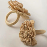 Talah Home natural straw flower napkin rings with wooden ring base, handcrafted Brazilian table decor.