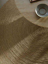Armadillo Nimbus Rug in Wasabi, a second view of the hand-braided new zealand wool rug in a styled interior