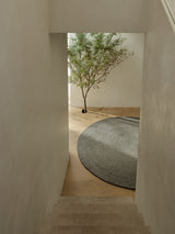 Armadillo Nimbus Rug in Oakmoss, detail of the hand-spun new zealand wool with jute stitching weave and texture