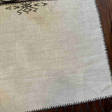 Noa Table Runner draped on a table — full length view showing tassels and linen texture