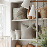 Dahlia Lumbar Pillow — side angle showing lumbar profile and embroidered end detail, styled on a neutral linen surface