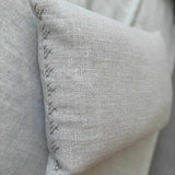 Close-up of wool hand embroidery on the end of the Dahlia Lumbar Pillow, showing texture and stitch detail on Belgian linen