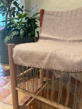 Elise Taupe Table Runner styled on a dining table, showing full length with tassel detail