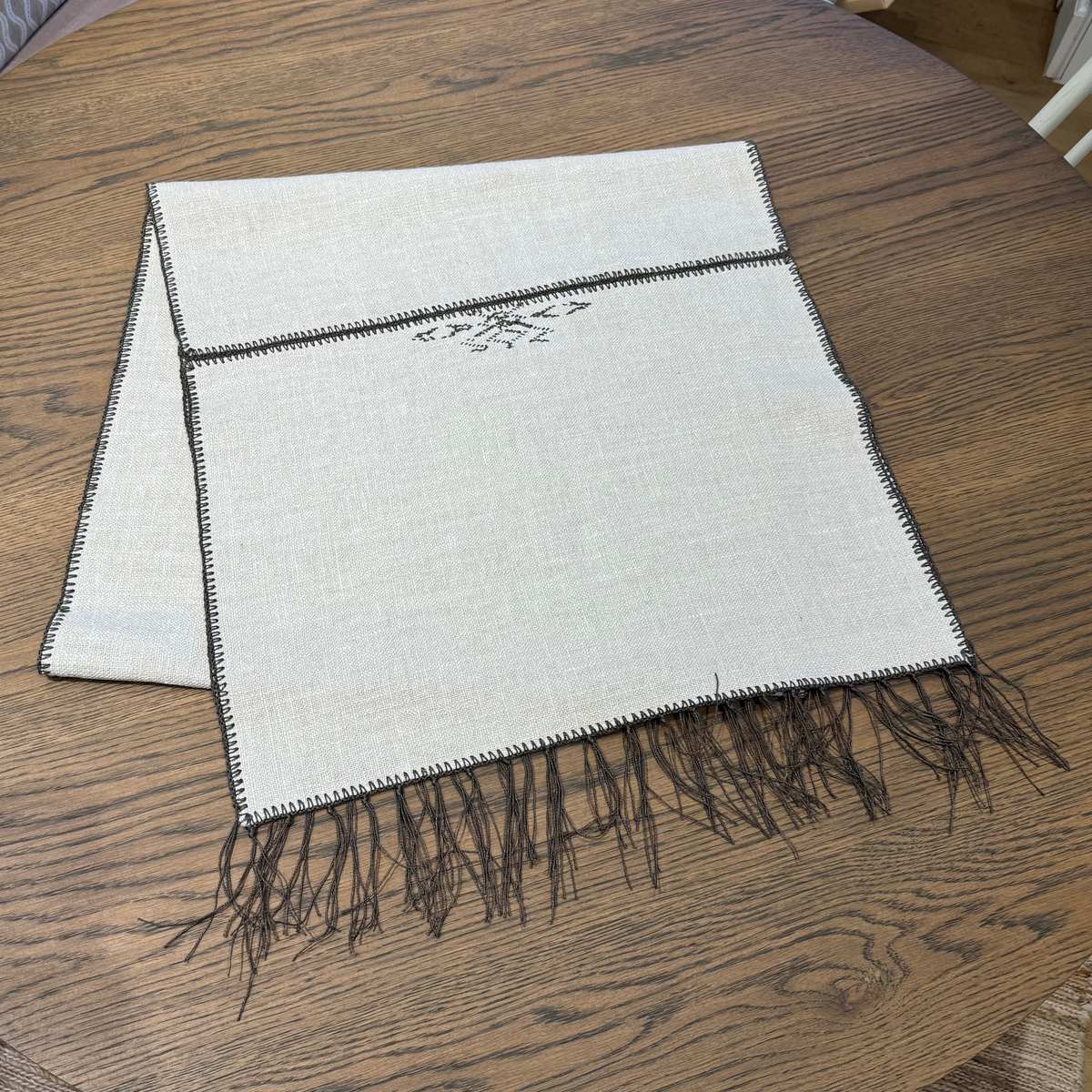 Noa Cream & Chocolate Table Runner by One Bi One — Belgian linen with chocolate wool embroidery and tassels, handcrafted in Gothenburg, Sweden