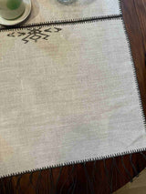 Noa Table Runner draped on a table — full length view showing tassels and linen texture