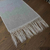Elise Gray & Cream Table Runner styled on a dining table — detail view showing embroidered pattern and tassel ends, by One Bi One