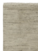 Armadillo Odessa Rug in Travertine, corner close-up of the afghan wool pile and edge