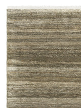 Armadillo Odessa Rug in Caraway, corner close-up of the afghan wool pile and edge