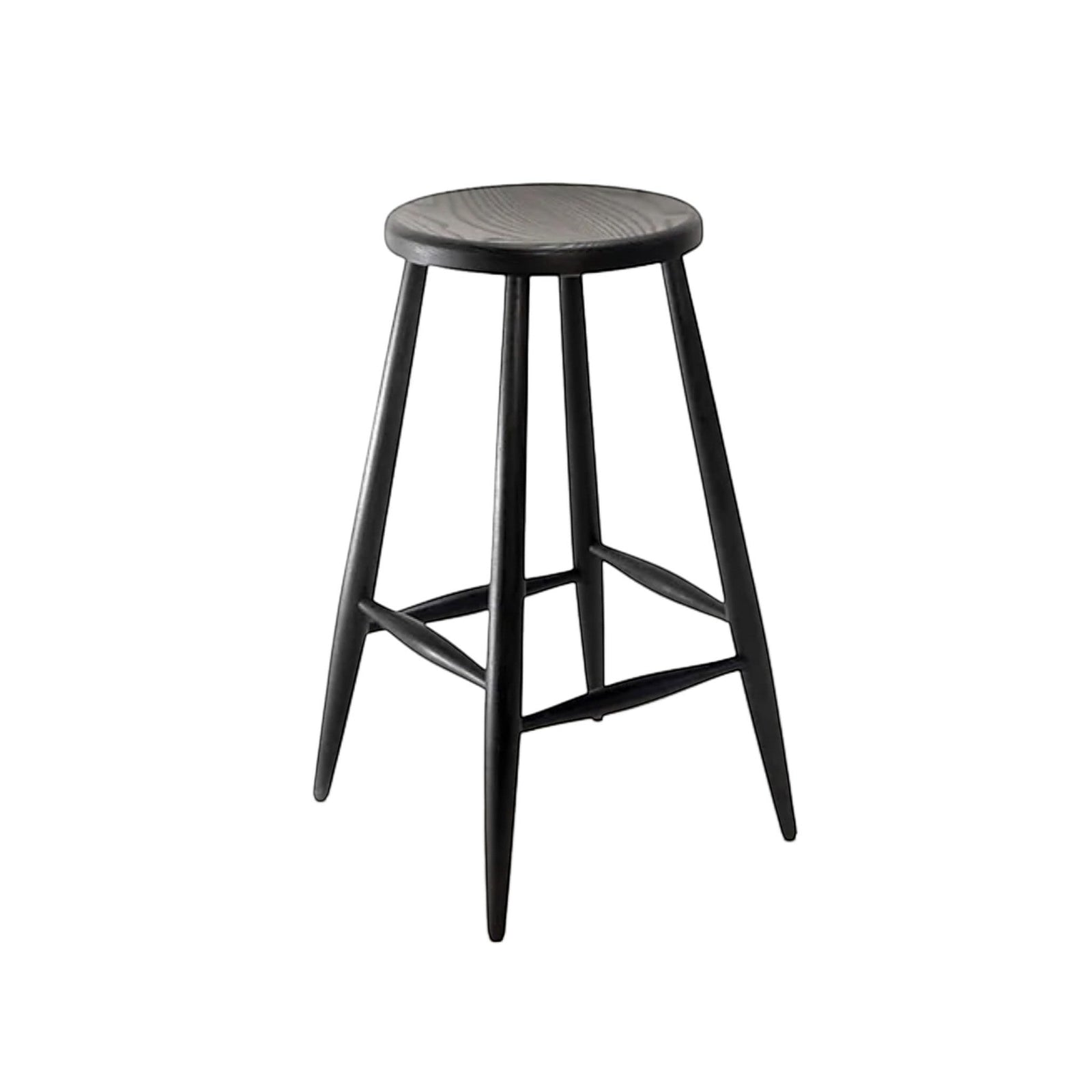 Calimia Home Omah stool in black stained wood with a round seat, tapered legs, and integrated footrests.