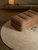 Armadillo Onsen Rug in Papyrus, a second view of the hand-braided wool and jute rug in a styled interior