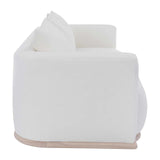 Calimia Home Owens sofa in white Belgian linen with a curved back and rounded oak plinth base, side profile view.