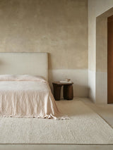 Armadillo Palermo Rug in Bone, hand-knotted linen rug shown in a room setting