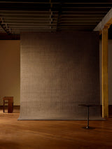Armadillo Palloza Rug in Shale, handwoven jute flatweave rug shown in a room setting