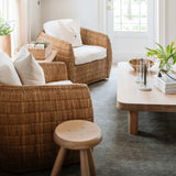 Palma Rectangular Coffee Table in natural oak by Grove & Anchor, styled in a living room with rattan armchairs and a wood stool