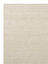 Armadillo Pebble Rug in Tofu, corner close-up of the hand-spun new zealand wool pile and edge