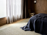 Armadillo Pebble Rug in Gravel, overhead view of the handwoven boucle wool weave and edge finish